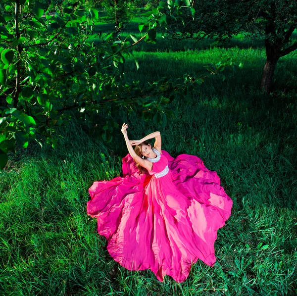 Mujer en un vestido largo rosa — Foto de Stock