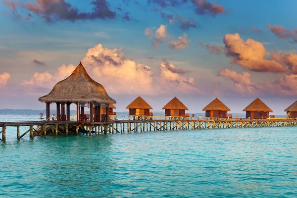 Villa on piles on water at the time sunset — Stock Photo, Image