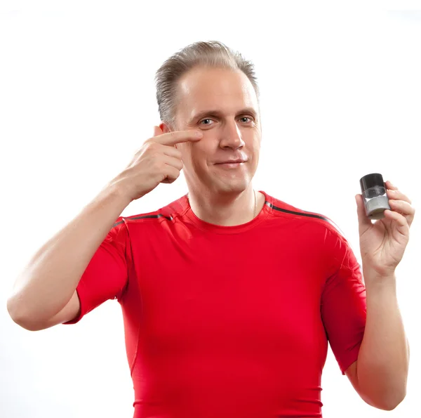 The mature well-groomed man cares of the appearance - uses against wrinkles cream — Stock Photo, Image