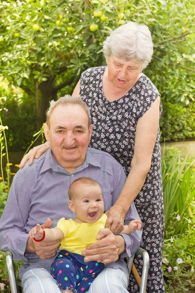 Elderly couple with granddaughter — Stock Photo, Image
