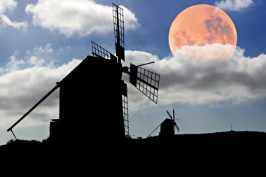 Moon setting over Spanish Windmills clipart