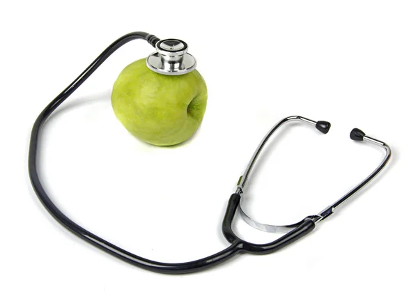 Zelené jablko s stetoskop — Stock fotografie
