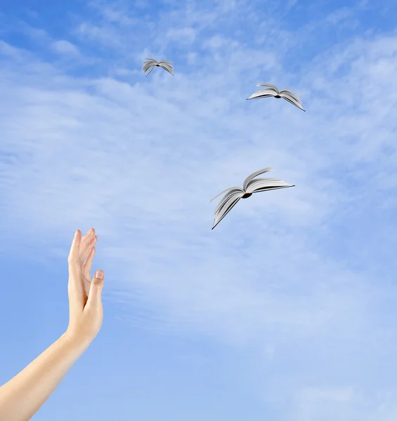 Books flying from hand — Stock Photo, Image