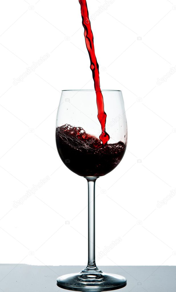 Dark red wine poured into a wine glass