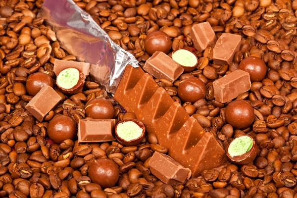 Diffirent types of chocolate and coffee beans — Stock Photo, Image