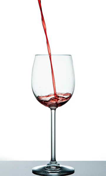 Start to pour red wine into wine glass — Stock Photo, Image