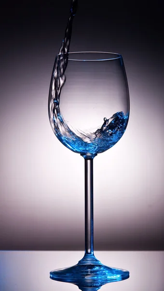 Liquid poured into backlid wine glass — Stock Photo, Image