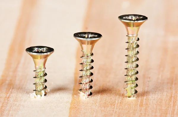 Tree screws in a wooden surface — Stock Photo, Image