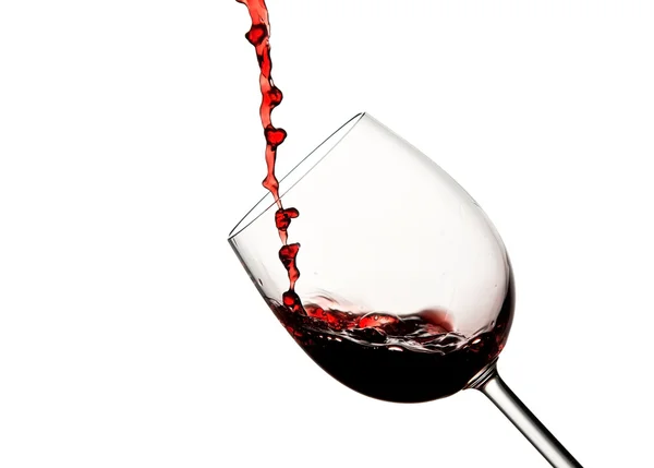 Crystal wine glass with pouring red wine — Stock Photo, Image