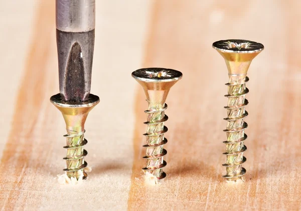 Screwdriver in first screw — Stock Photo, Image