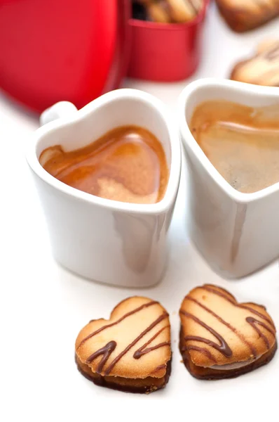 Heart shaped cream cookies on red heart metal box and coffee — Stock Photo, Image