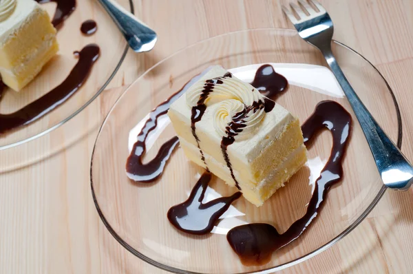 stock image Fresh cream cake closeup with chocolate sauce