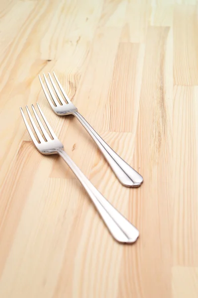 Two fork on a pinewood table — Stock Photo, Image
