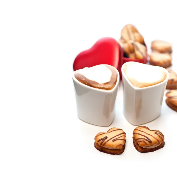 Heart shaped cream cookies on red heart metal box and coffee — Stock Photo, Image