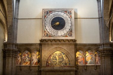 Florence - Duomo interior. Huge clock decorated by Paolo Uccello. clipart