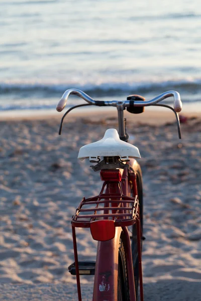 stock image Old red bike on the beach