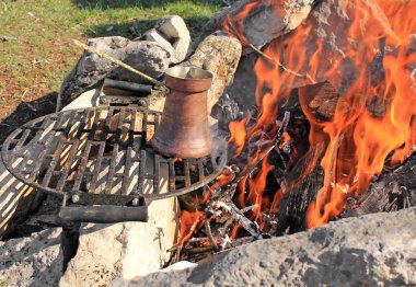 Coffee pot on a fire clipart