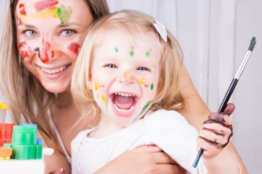 Happy mother and daughter painting clipart