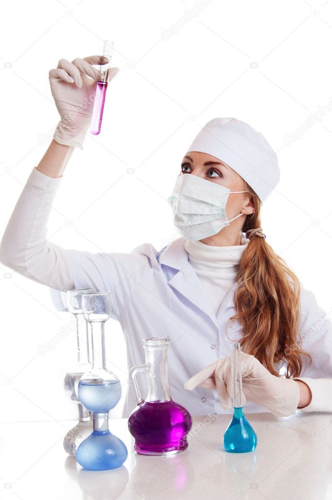 Scientist woman in lab coat with chemical glassware