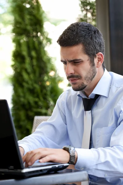 Busy businessman working on laptop — Stock Photo, Image
