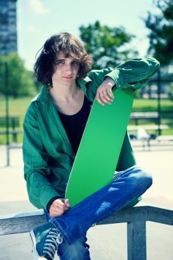 Skater posing with his skateboard clipart