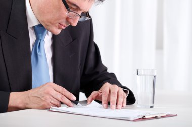 Senior businessman checking contract clipart