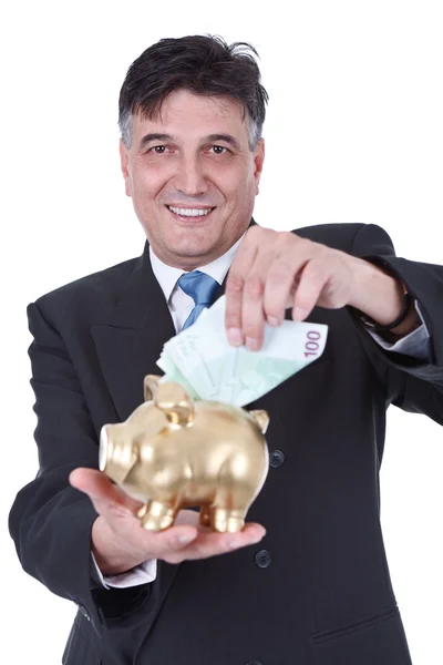 Zakenman met piggy bank en geld — Stockfoto
