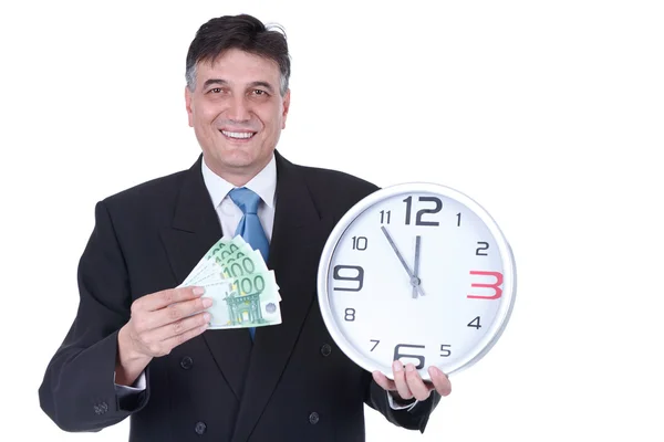 Empresário sênior com dinheiro e relógio de parede — Fotografia de Stock