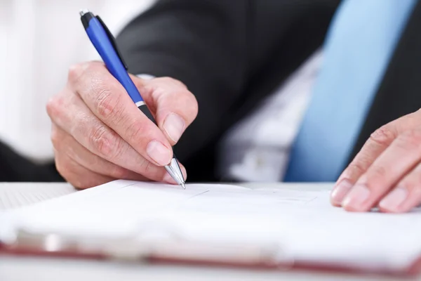 Stock image Close up of businessman signing a contract.