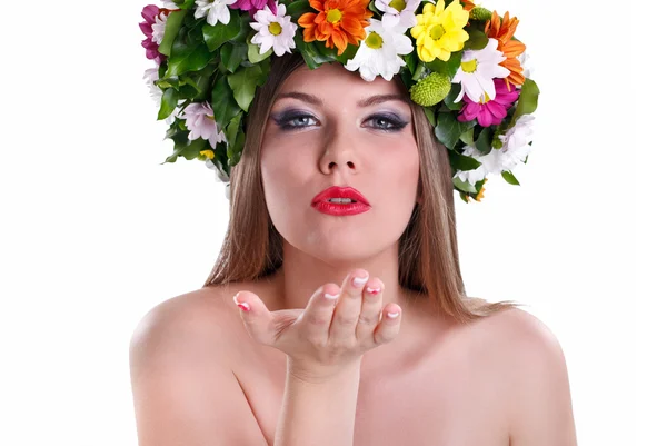 Girl in wreath and blowing in the hand — Stock Photo, Image
