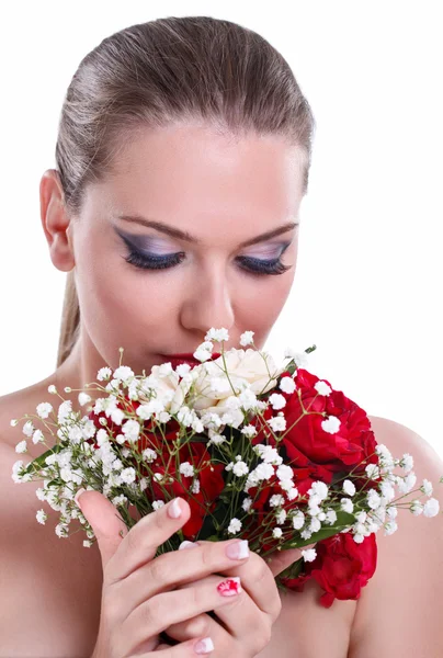 Woman smelling flowers — Stock Photo, Image