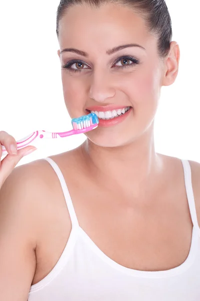 Beautiful young woman brushing her teeth — Stock Photo, Image