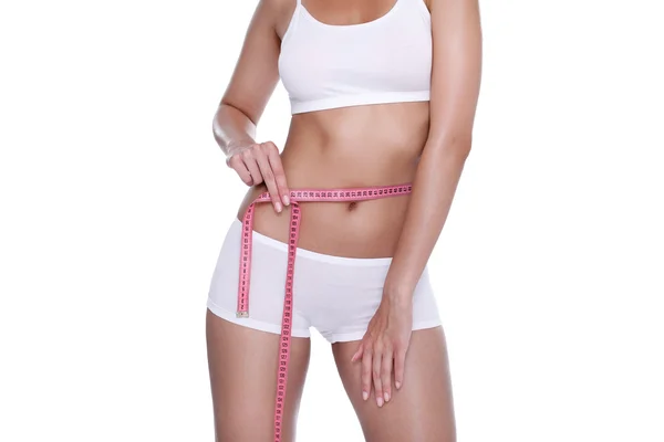 Woman and measure tape around her body — Zdjęcie stockowe