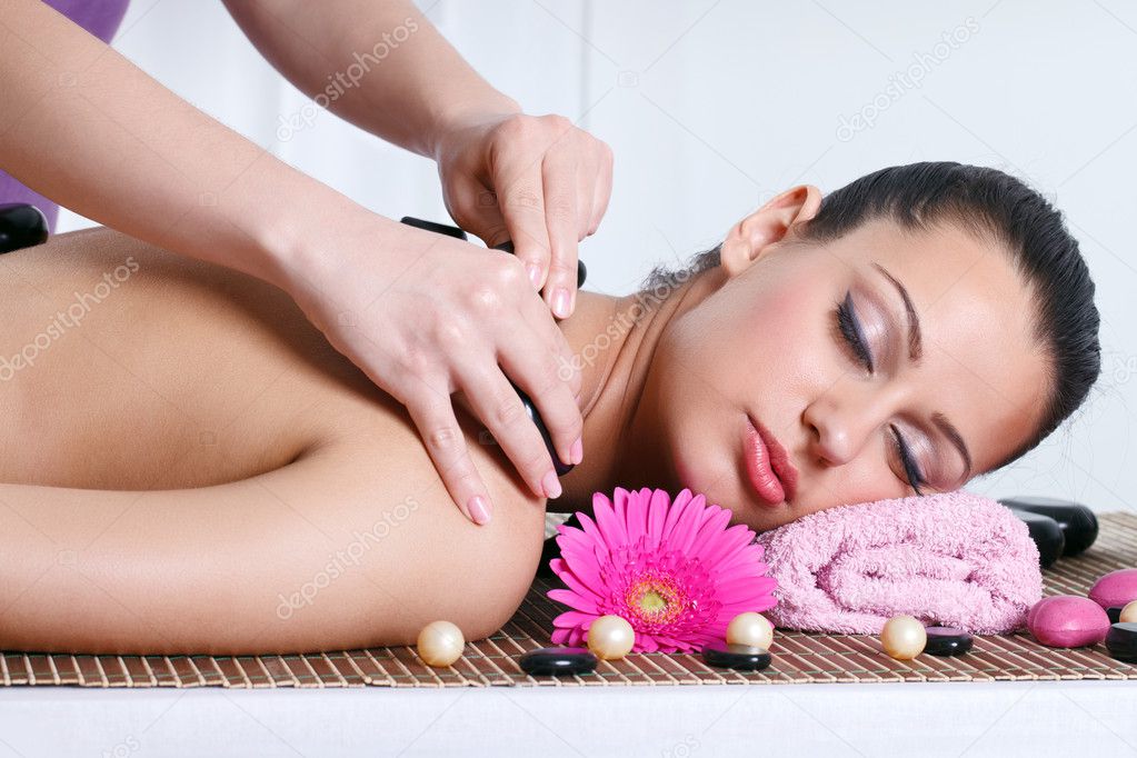 Young woman receiving a back massage in a spa center stock photo