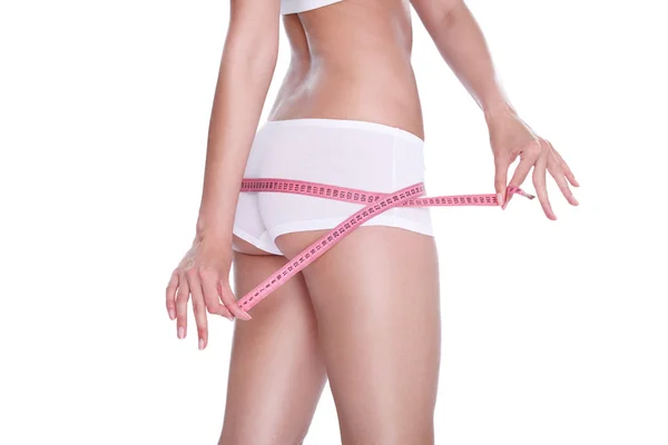 Slim girl measuring her hips — Stock Photo, Image