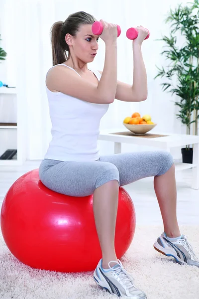 Girl Exercising with dumbbells and pilates ball — Stock Photo, Image