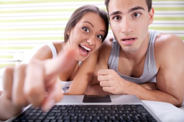 Funny couple chatting over laptop clipart