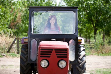 Woman driving tractor clipart