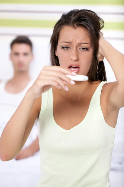 Shocked woman with pregnancy test — Stock Photo, Image