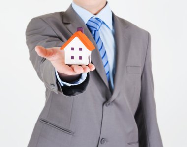 Businessman with a house clipart