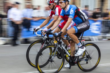 Saint Quentin, France, July 5th 2011:Panning image of two cyclists from Garmin-Sharp team and Katusha Team clipart