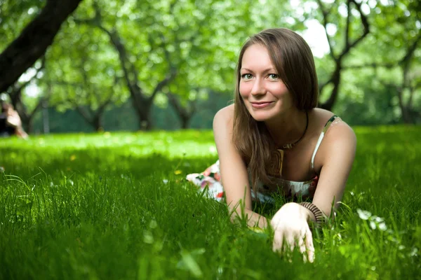 Beautiful woman is lying on the grass Royalty Free Stock Images