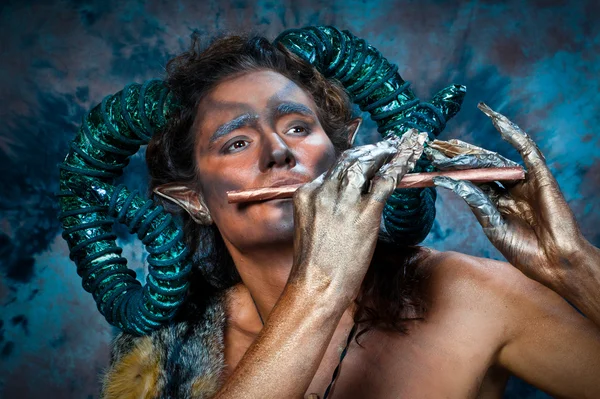 Faun playing the flute Stock Image