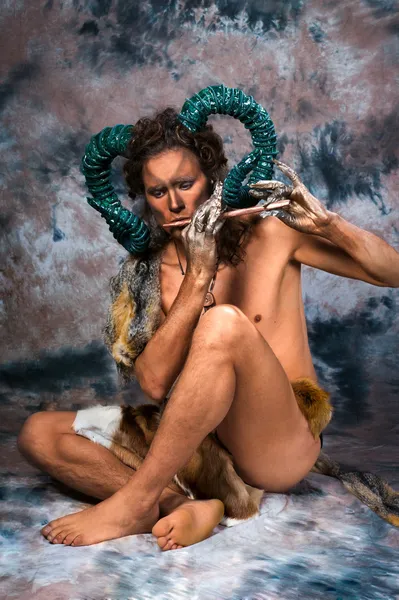 Faun playing the flute Royalty Free Stock Images