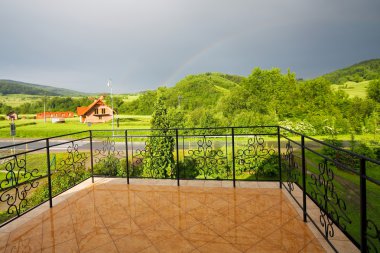 Panorama of the green mountain from a balcony clipart