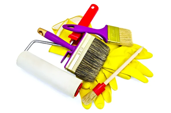 Brushes of various sizes with yellow gloves and roller — Stock Photo, Image