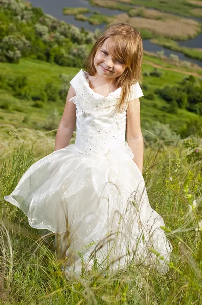 Menina bonita na roupa da noiva no campo com o fie — Fotografia de Stock