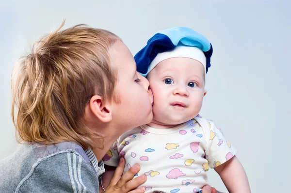 Elder brother kisses in a cheek junior brother — Stock Photo, Image