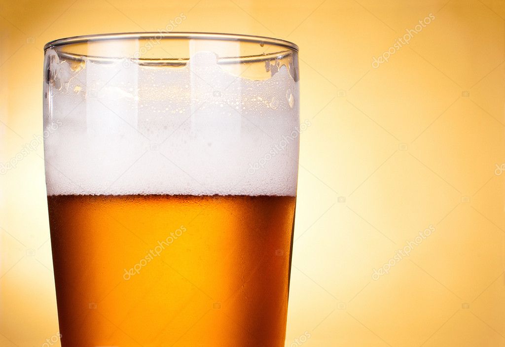 Glass of beer with froth close up