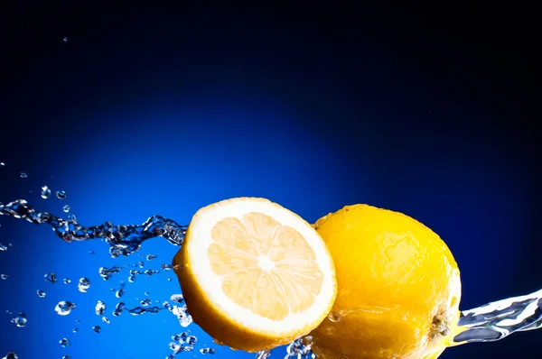 Taze limon ve yarı karanlık bir su sıçramalarına limon — Stok fotoğraf